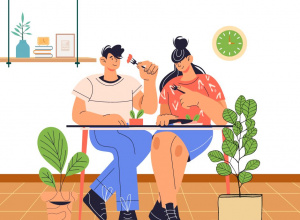 Grafika, na której chłopak i dziewczyna jedzą obiad przy stoliku. Obok stolika stoją kwiaty w doniczce. Na ścianie wisi zegar i półka.