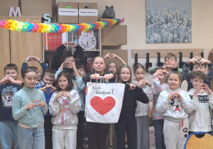 Klasa prezentuje wykonany plakat - na białym tle czerwone serce.
