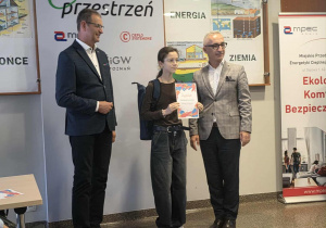 Uczennica odbiera nagrodę za wyróżnioną pracę plastyczną